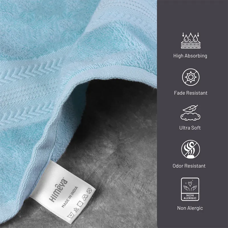 Blue textured bath towel shown close up with a folded corner