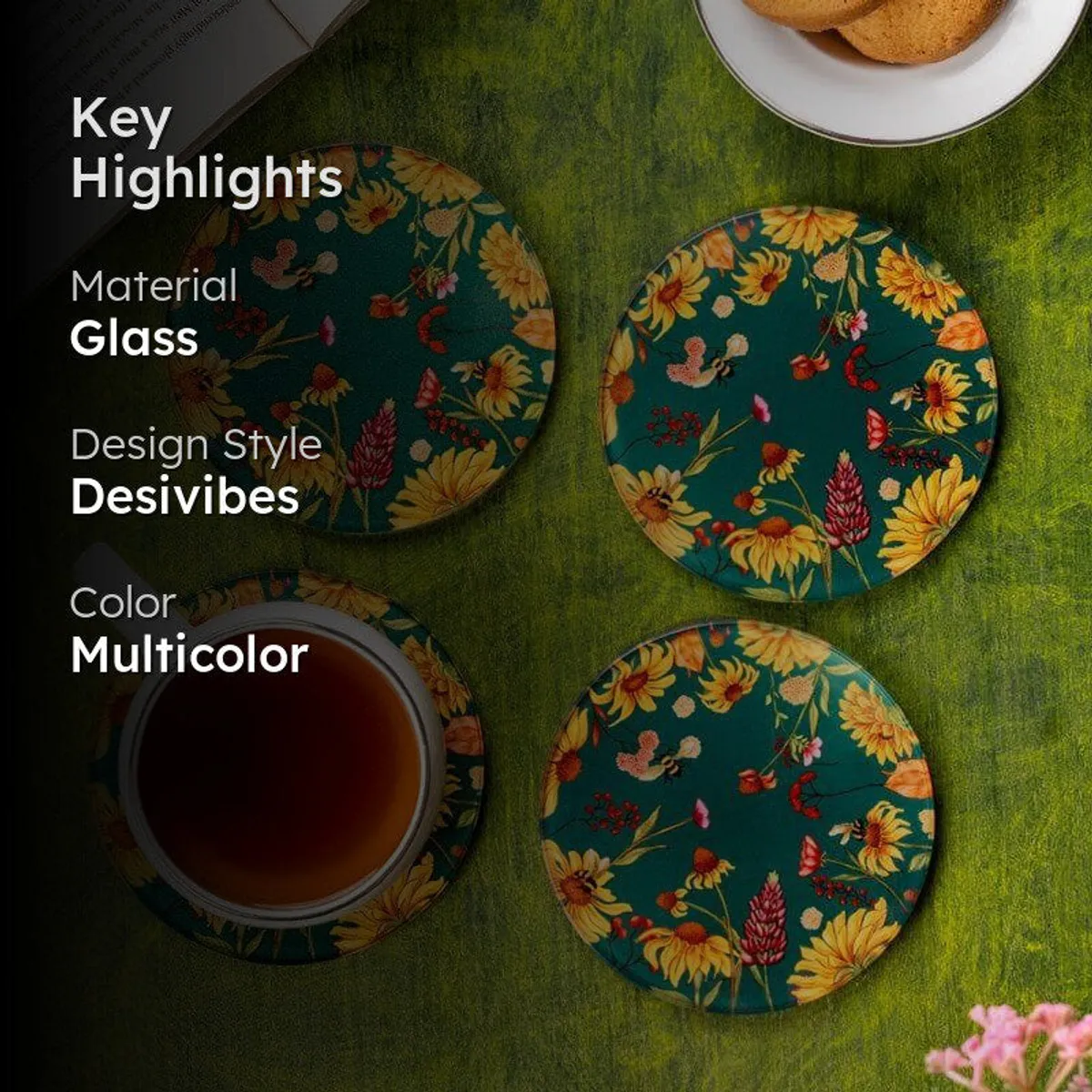 Floral round coasters styled on a green tabletop with a teacup, cookies and an open book.