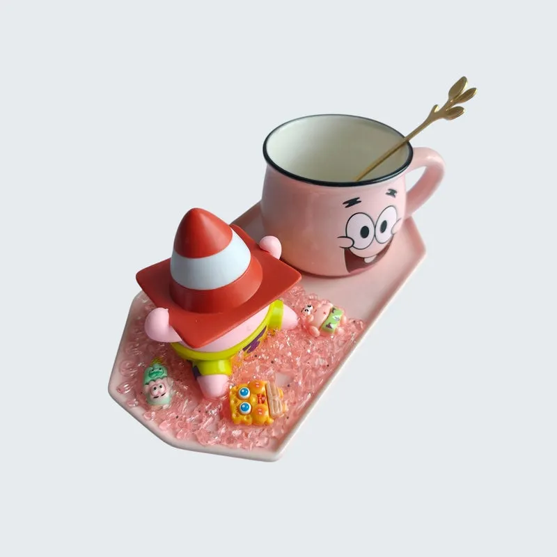 Top angled view of pink character mug, figurine and spoon on a tray