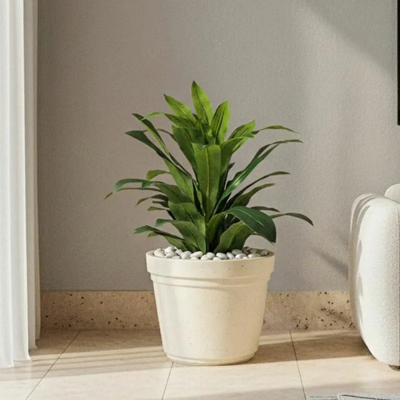 Off-white planter holding a leafy green plant in a living room