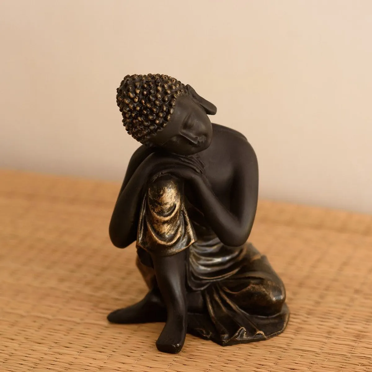 Close view of black Buddha resin showpiece with antique-style highlights