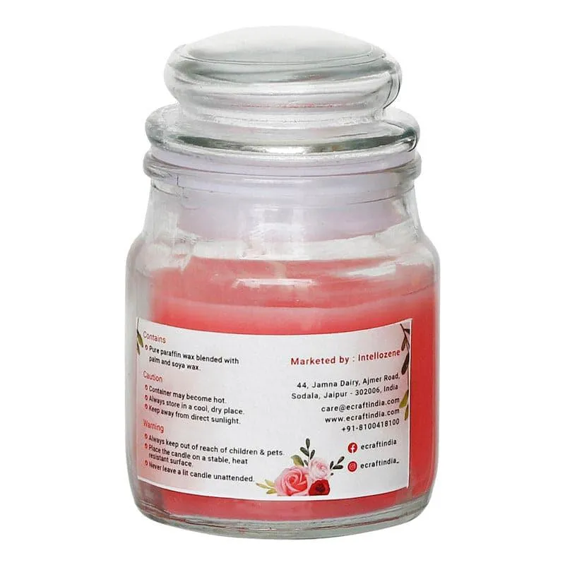 Back view of pink candle in a clear glass jar with fitted lid