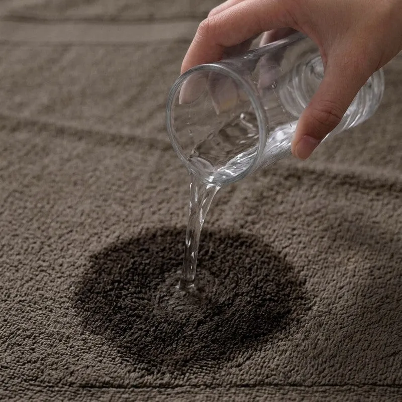 Close-up of water poured onto a grey towel surface