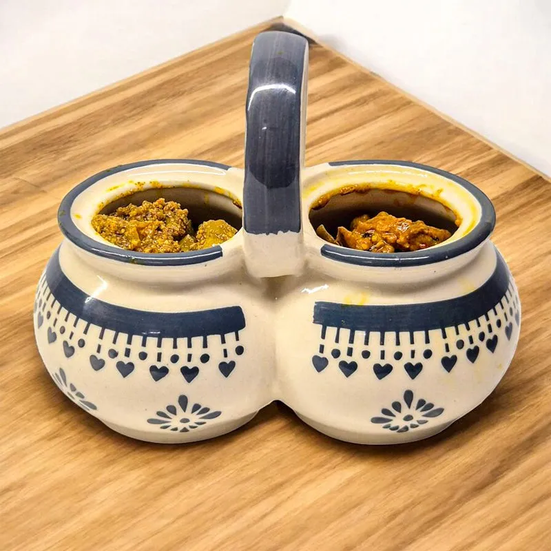 Open blue and white dual ceramic jar showing two condiment compartments.