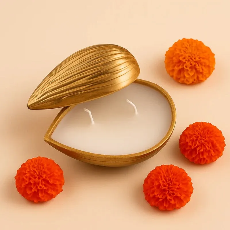 Open golden almond-shaped candle surrounded by orange flowers