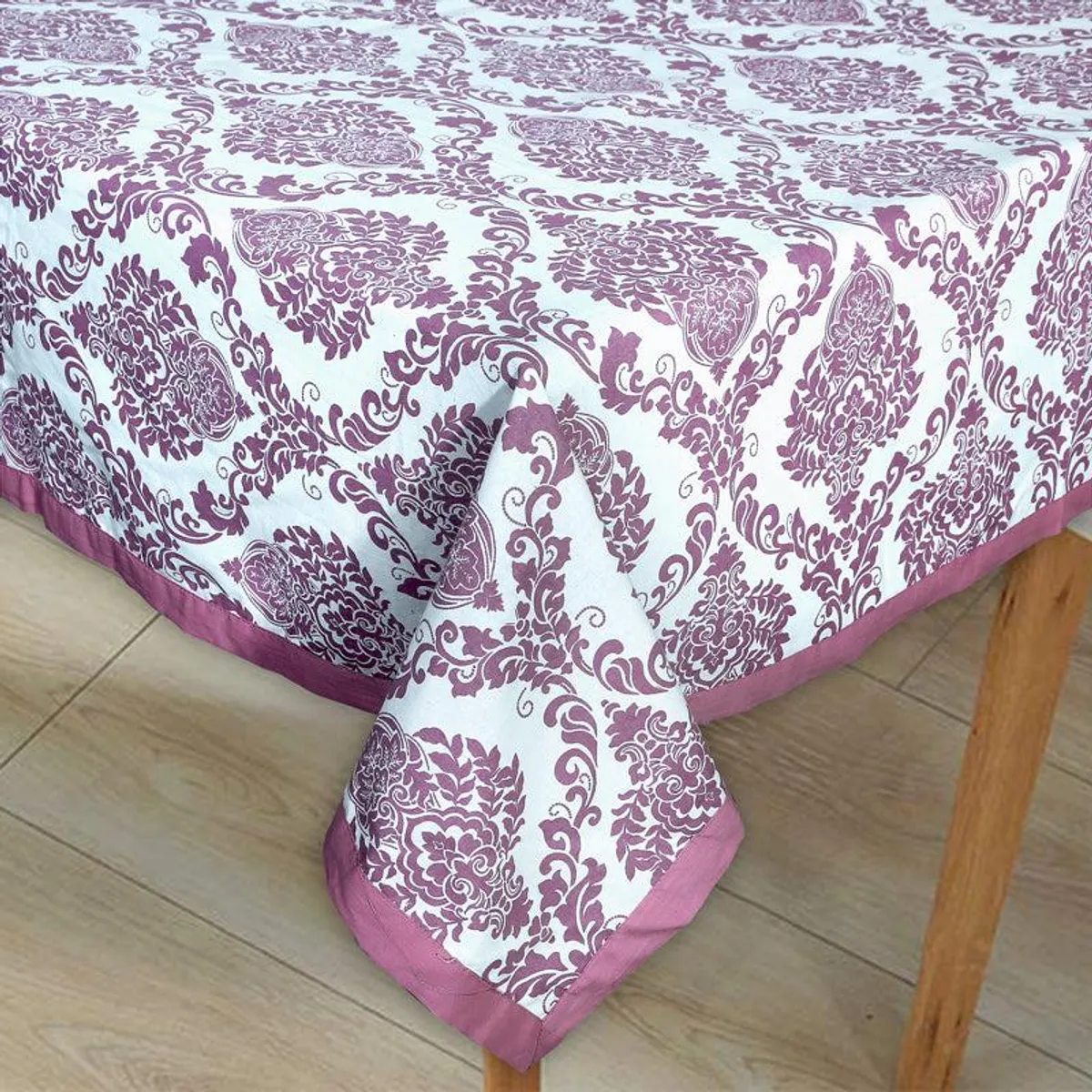 Close-up of the purple damask pattern and bordered edge on the table cover
