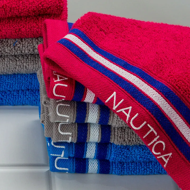 Close-up of burgundy, grey and blue plush striped towels with Nautica branding