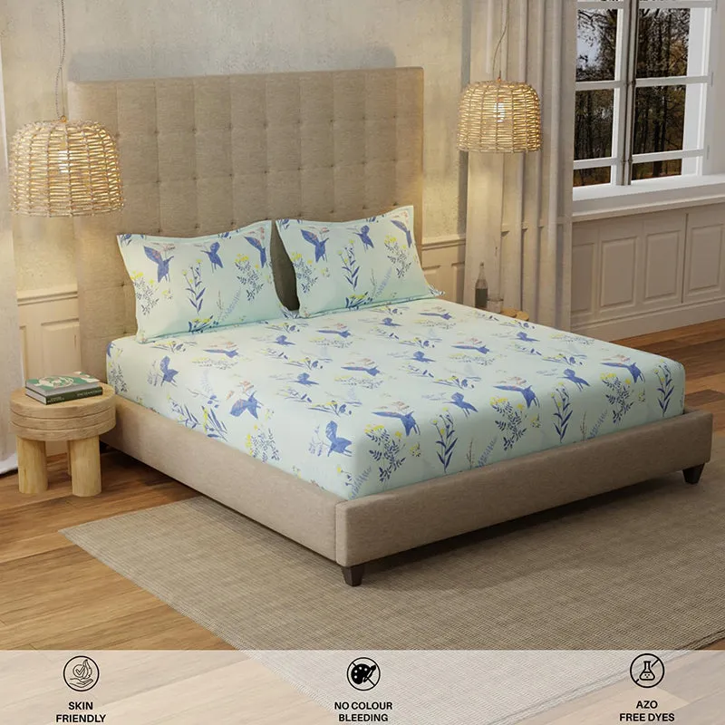 Angled bedroom view with mint blue printed bedsheet and matching pillow covers