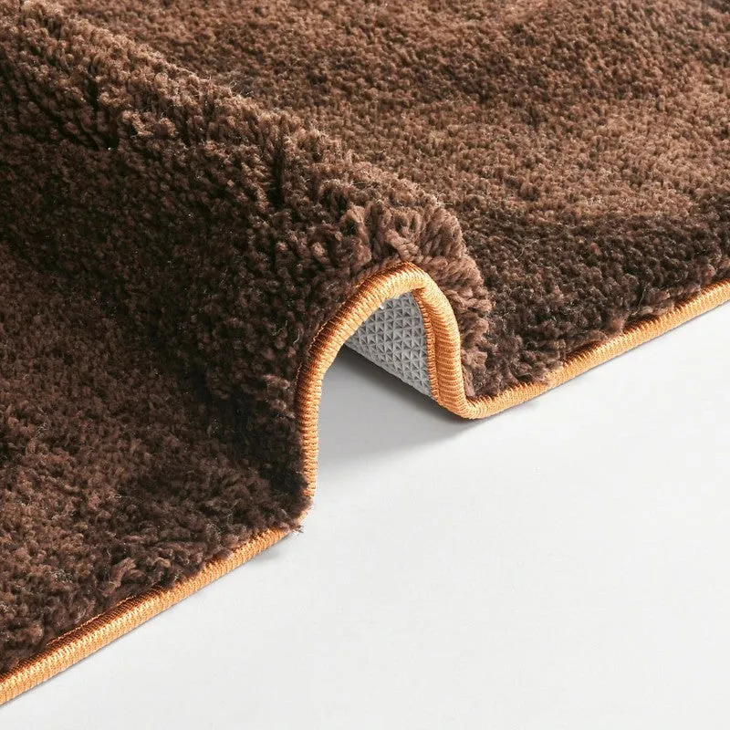 Close-up of brown bath mat edge and textured pile