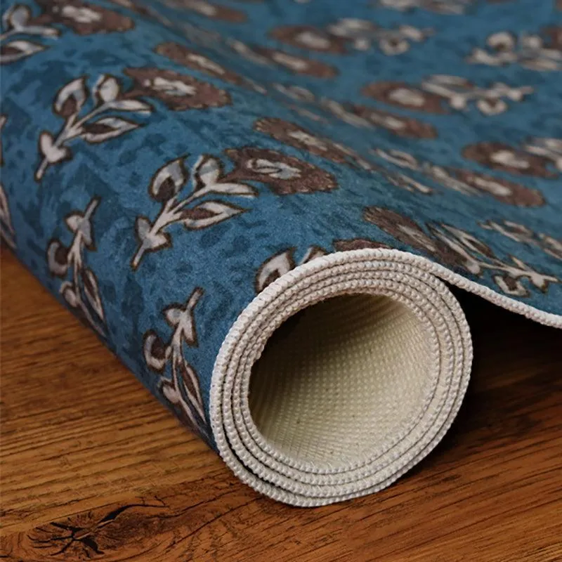 Rolled blue carpet showing patterned surface and light backing