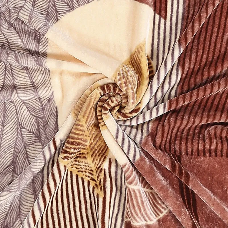 Close-up of the blanket's multicolour abstract leaf and stripe pattern