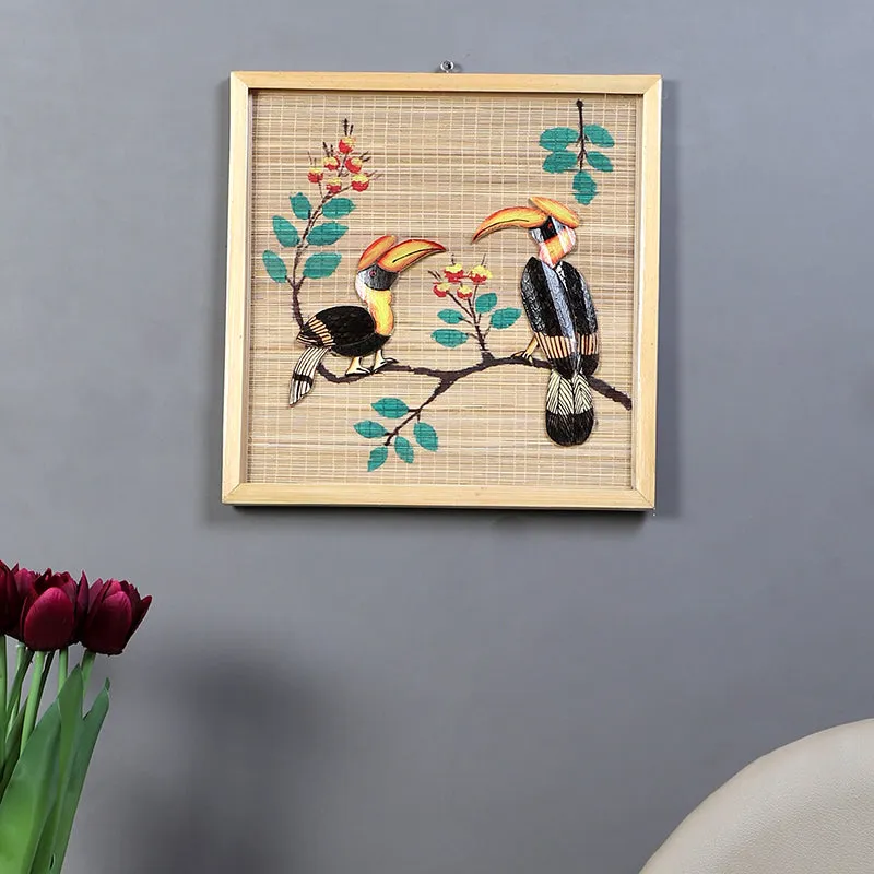 Framed toucan bamboo wall art displayed on a grey wall above a console setting.