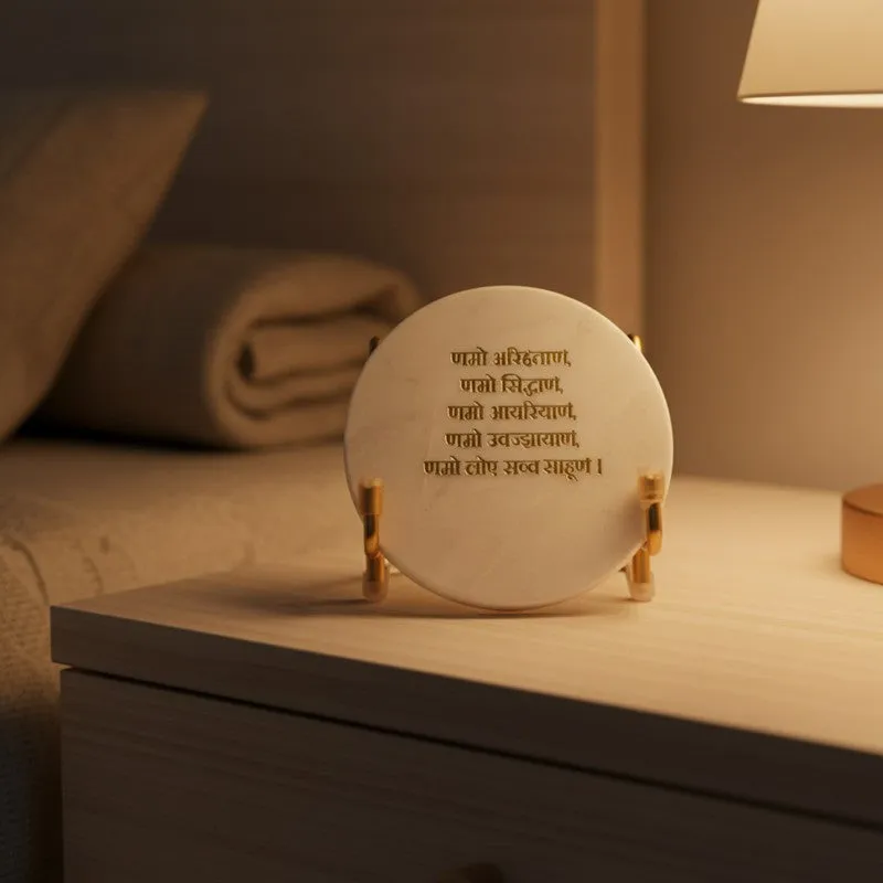 White marble mantra showpiece placed on a bedside table