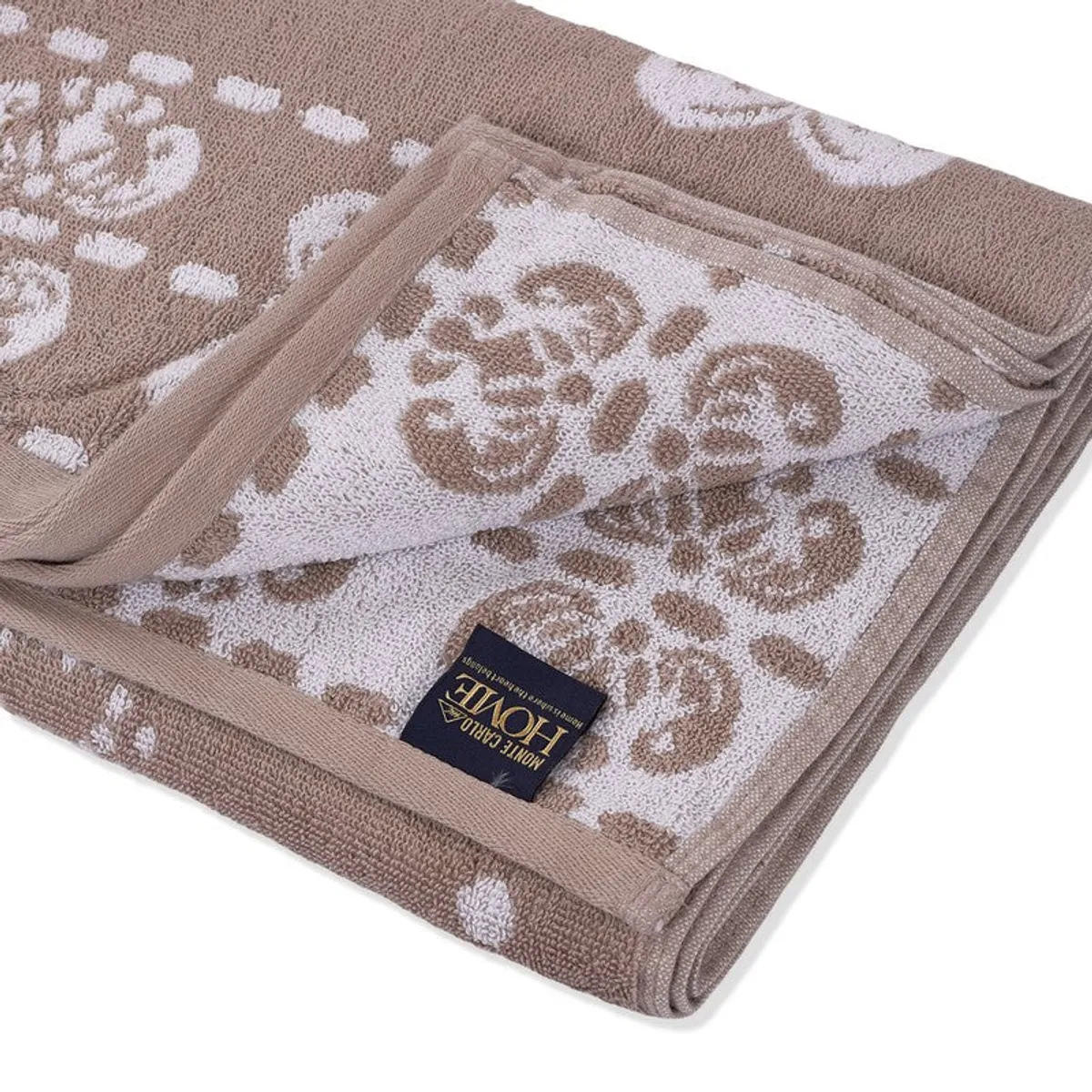Close-up of the towel's soft textured floral surface and folded edge