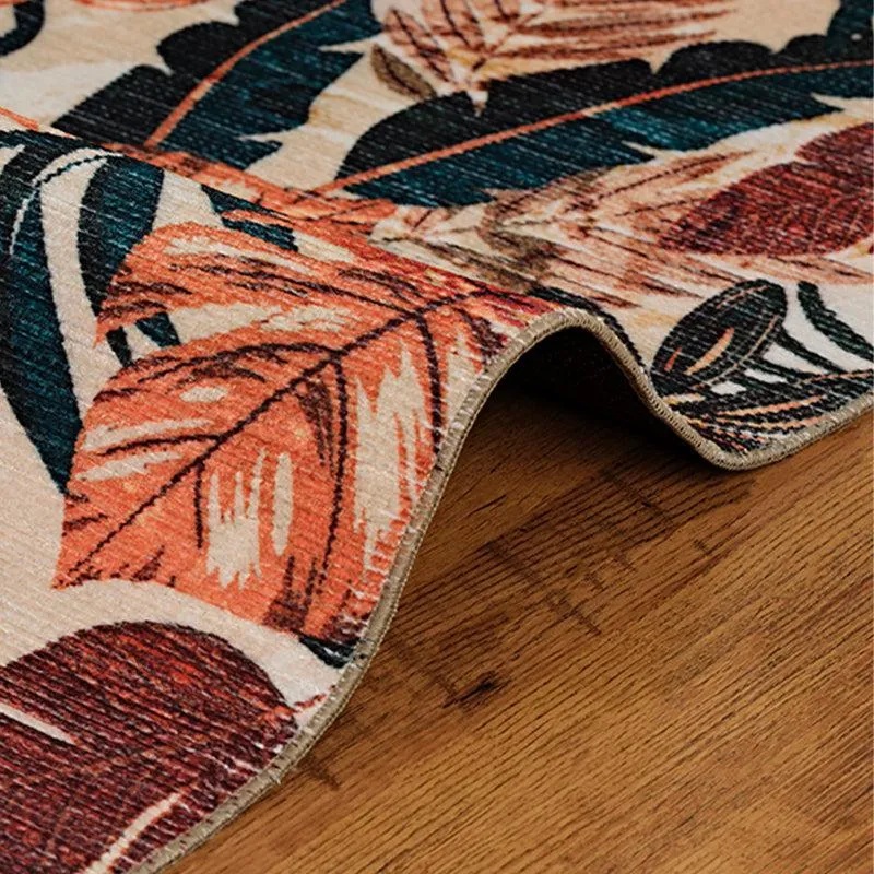 Close-up of carpet edge with tropical print on wooden floor