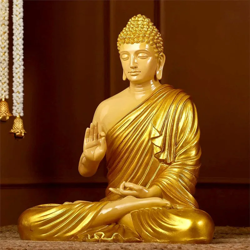 Front view of a seated gold Buddha idol in meditation pose.