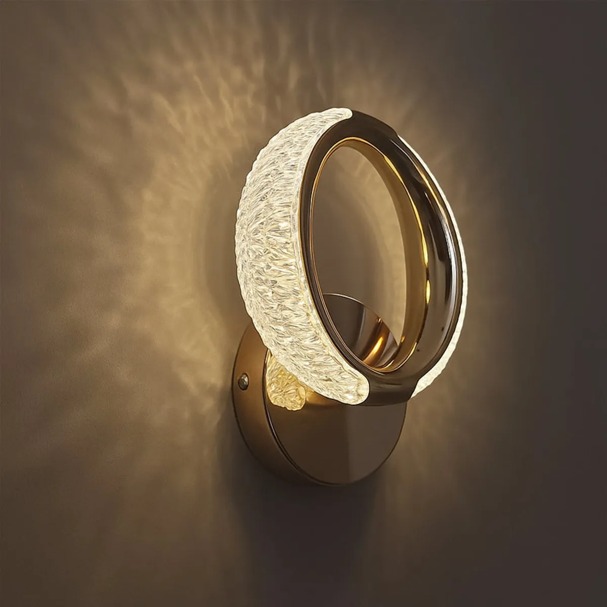 Close-up side view of the glossy gold circular wall lamp with textured acrylic shade