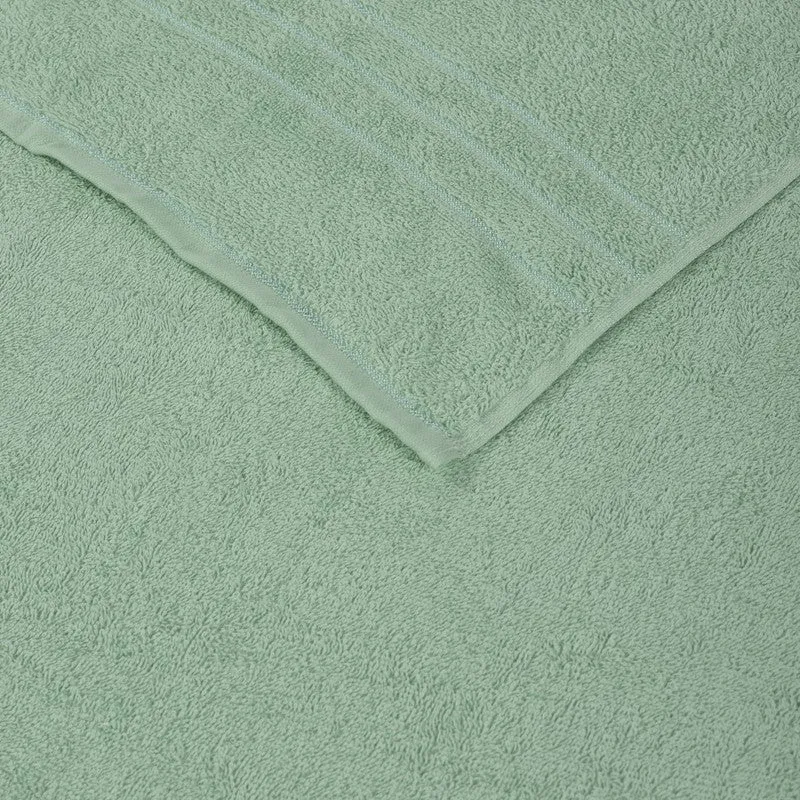 Close-up of sage green towel surface and border detail