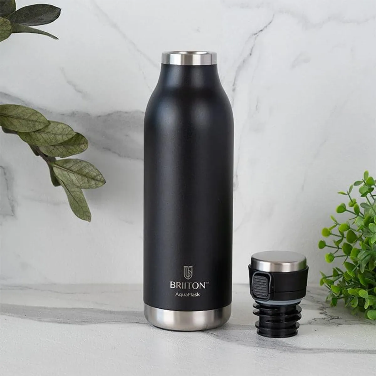 Black bottle with its detached lid displayed beside it