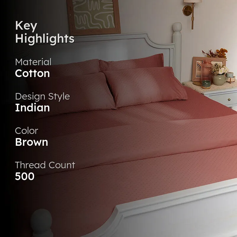 Pink-brown dotted duvet cover styled on a bed in a bedroom