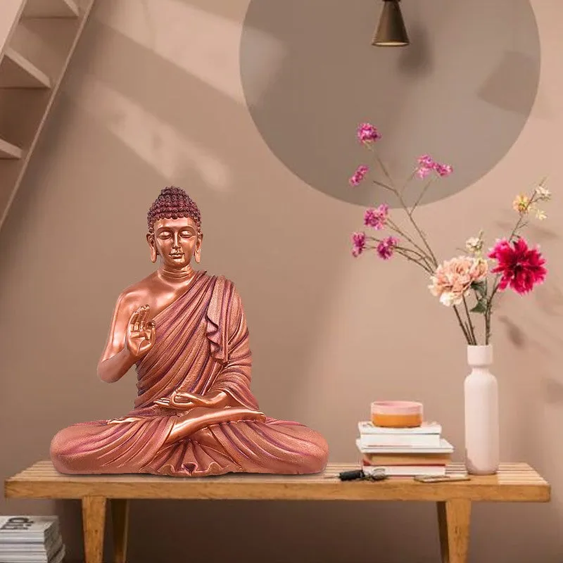 Copper Buddha idol displayed on a wooden console table