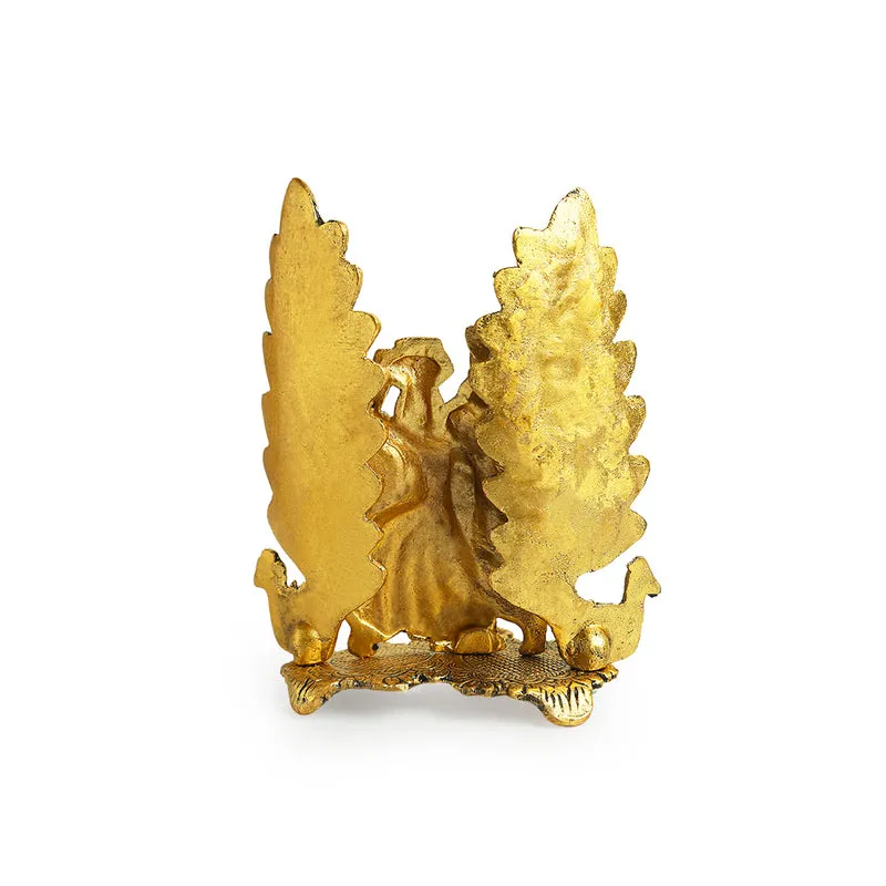 Back view of the gold-toned diya showpiece on a white background