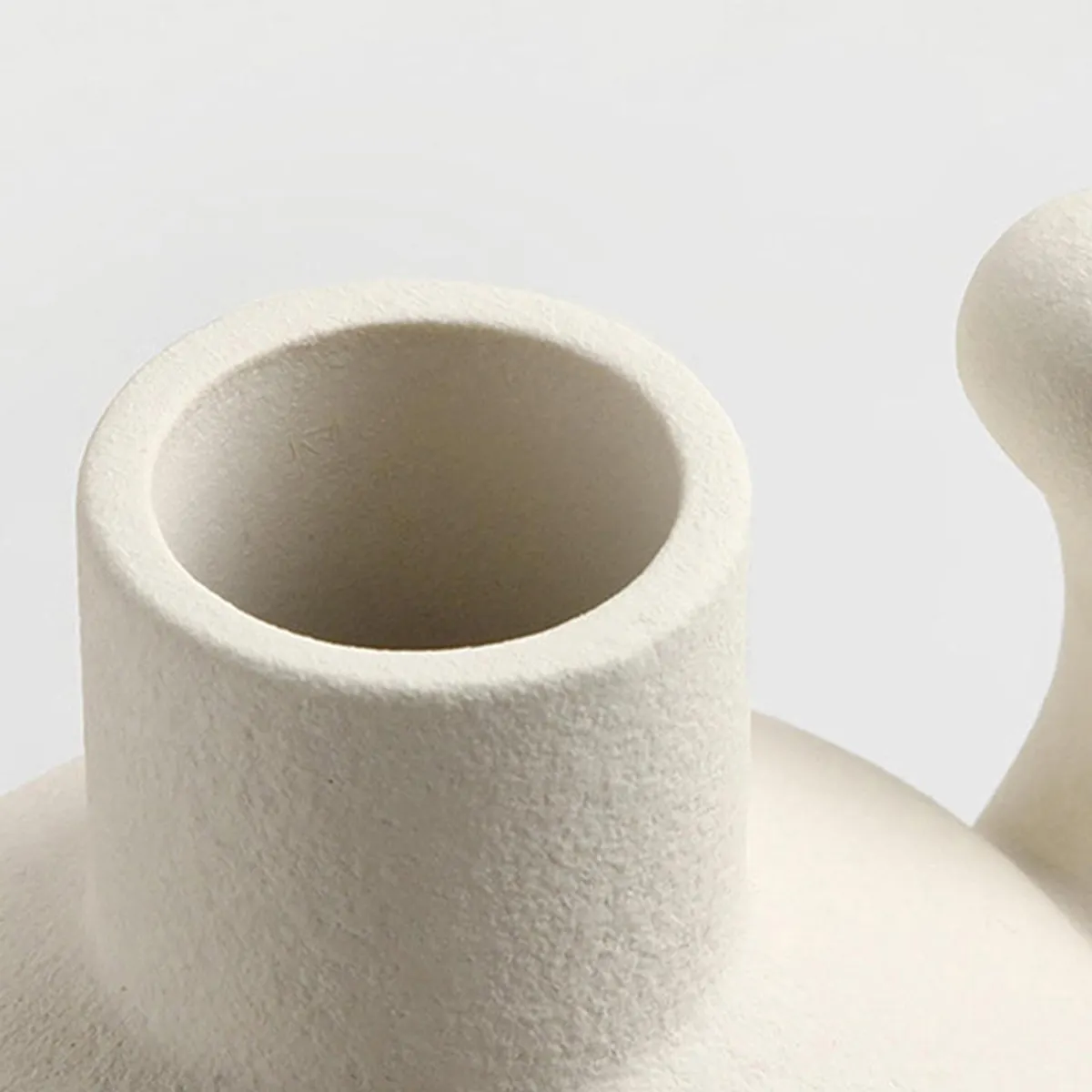 Close-up of the vase opening and textured white porcelain surface