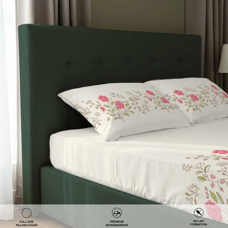 Close-up of floral pillow covers and white bedsheet on green bed
