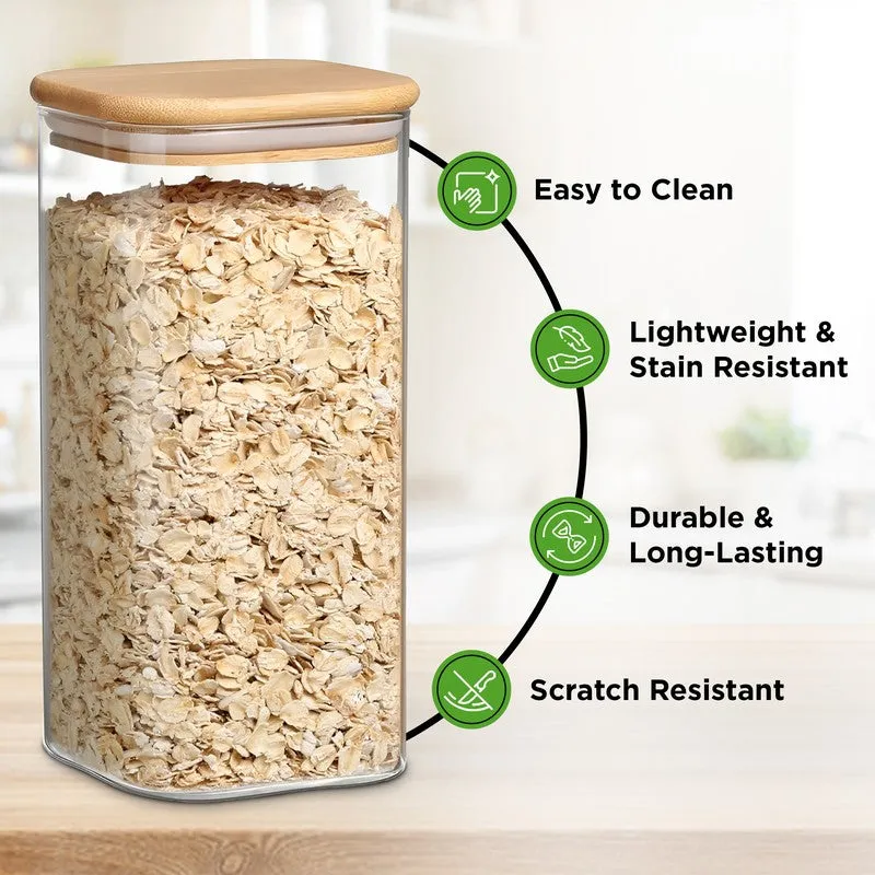 Transparent glass jar with bamboo lid filled with oats, shown in a kitchen setting