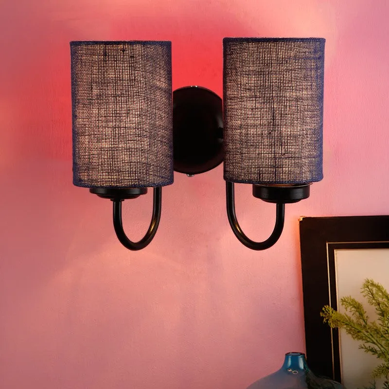 Front view of navy blue double wall lamp with lit jute shades