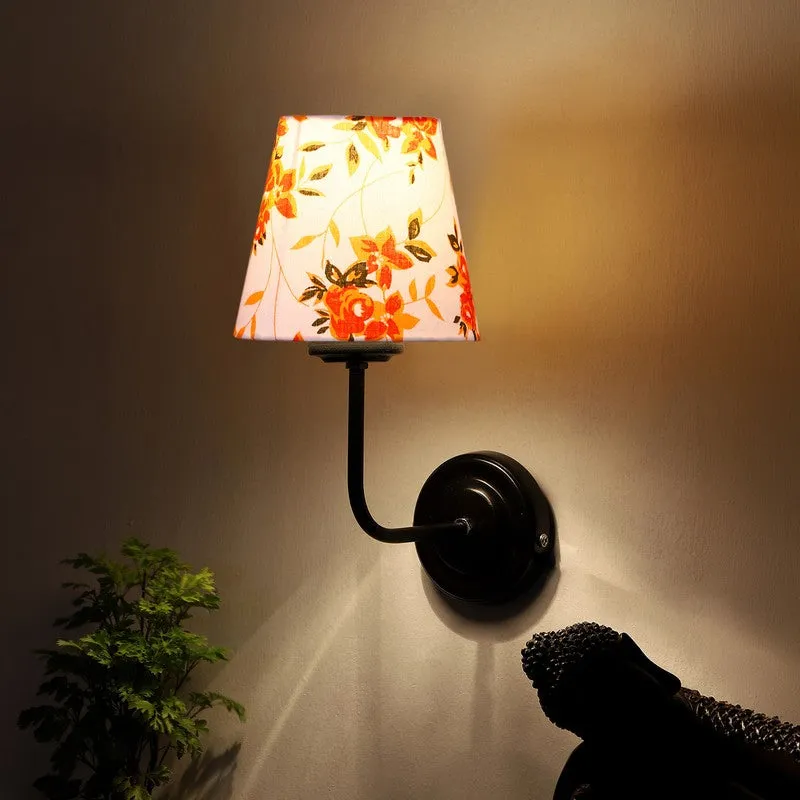 Lit wall lamp with orange floral cotton shade and black iron arm