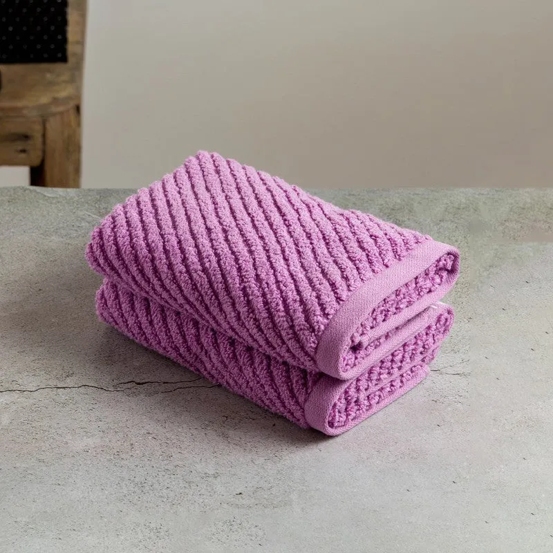 Folded lilac ribbed hand towel on a neutral surface