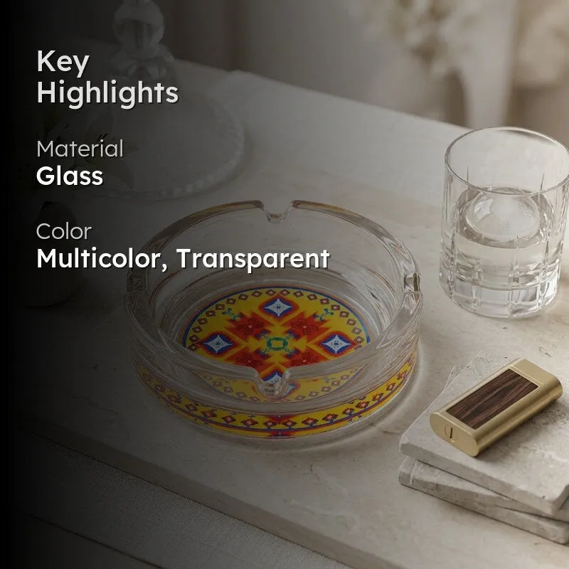 Transparent glass ashtray with colourful geometric design styled on a tabletop