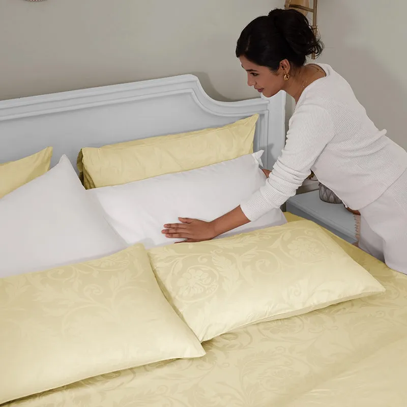 Bedroom scene showing the ivory floral duvet cover being arranged