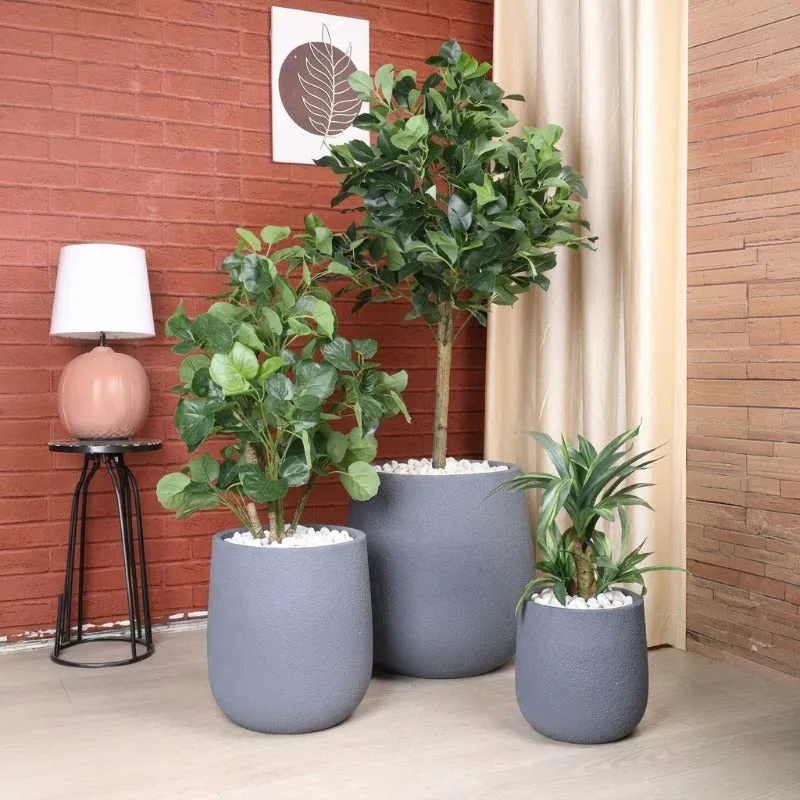 Three grey planters in different sizes arranged with indoor plants
