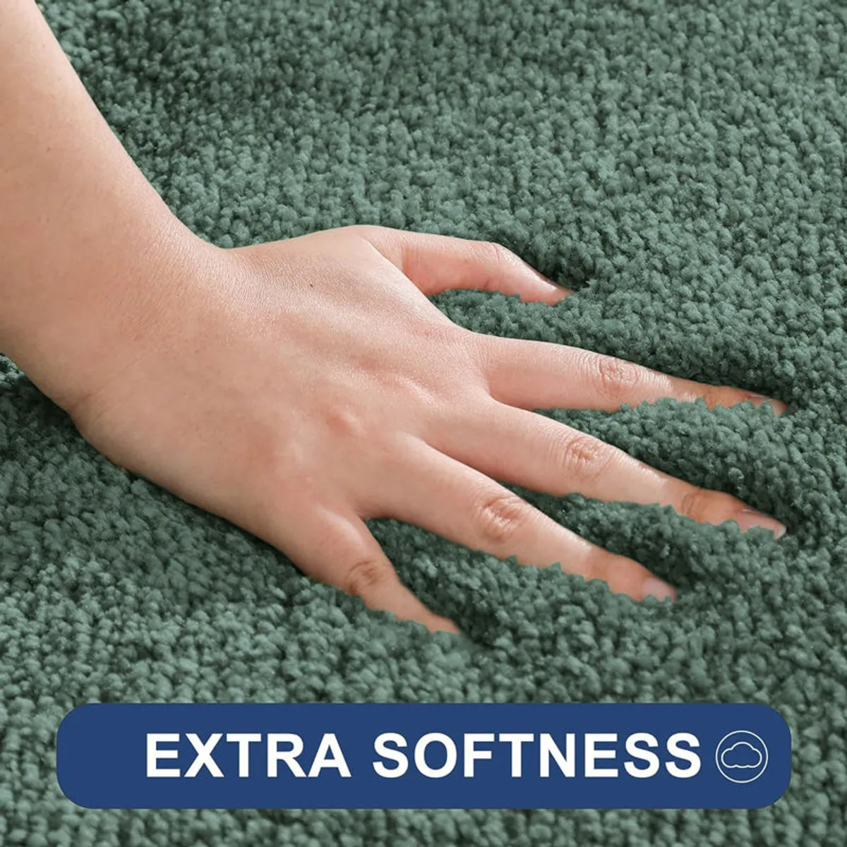 Hand pressing into the soft green rug surface