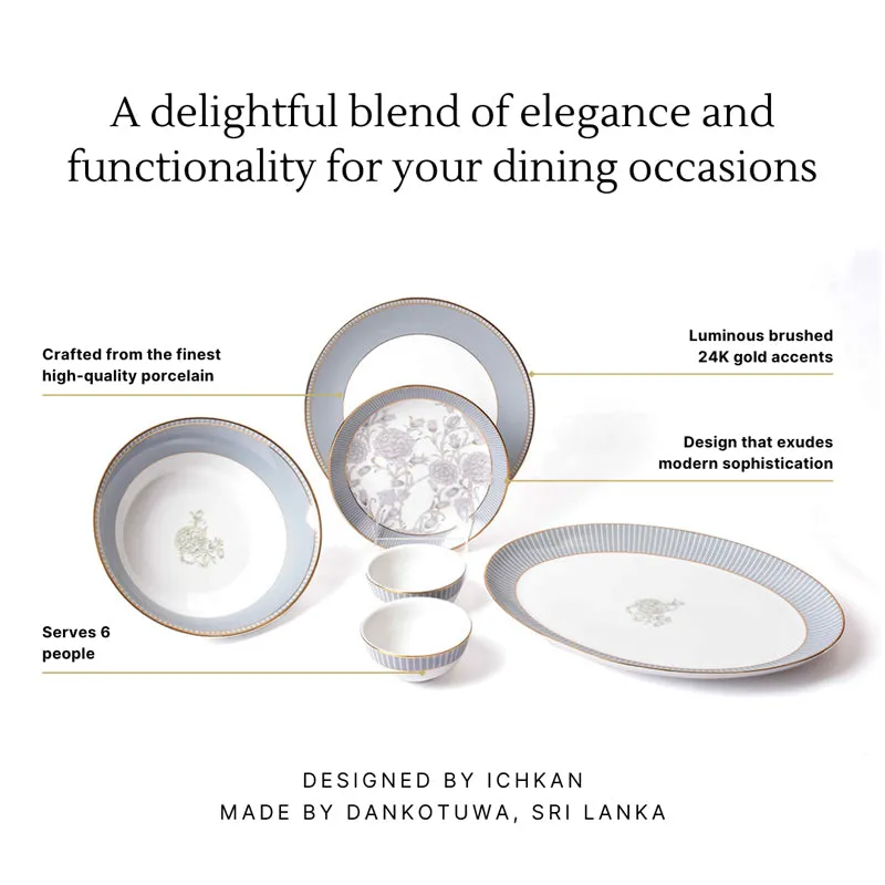 Grey porcelain dinner set displayed with plates, bowls, gold edging and floral motifs