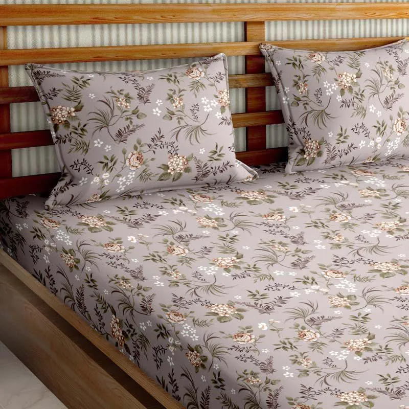 Angled view of grey floral bedsheet spread over a double bed