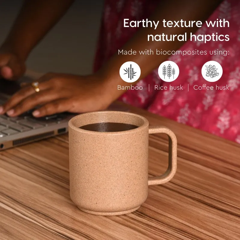 Brown coffee mug on a desk with a laptop and natural-texture finish