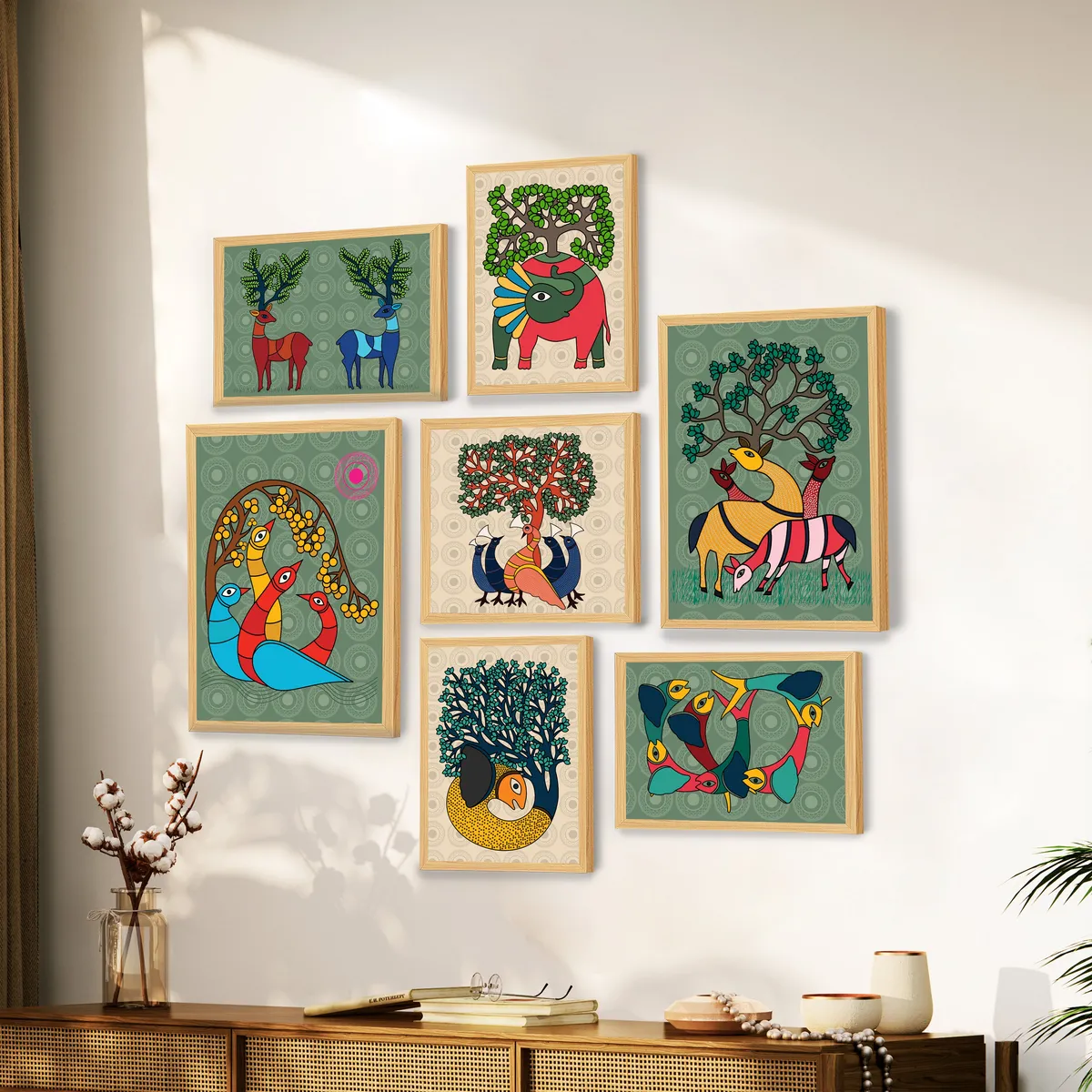 Seven framed folk-style prints arranged on a bright wall above a wooden cabinet.