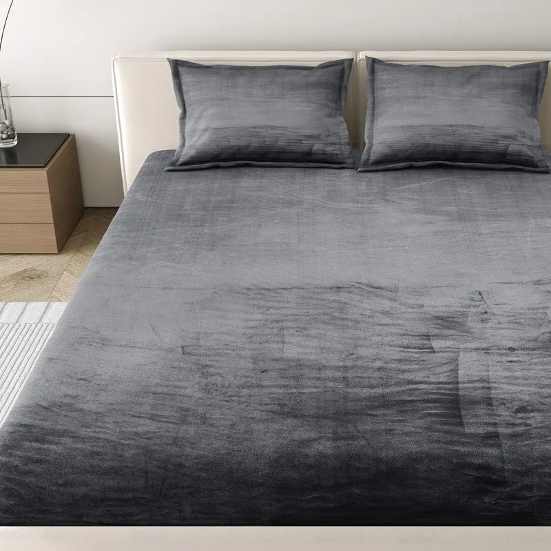 Close view of the black and grey bedsheet spread across the bed