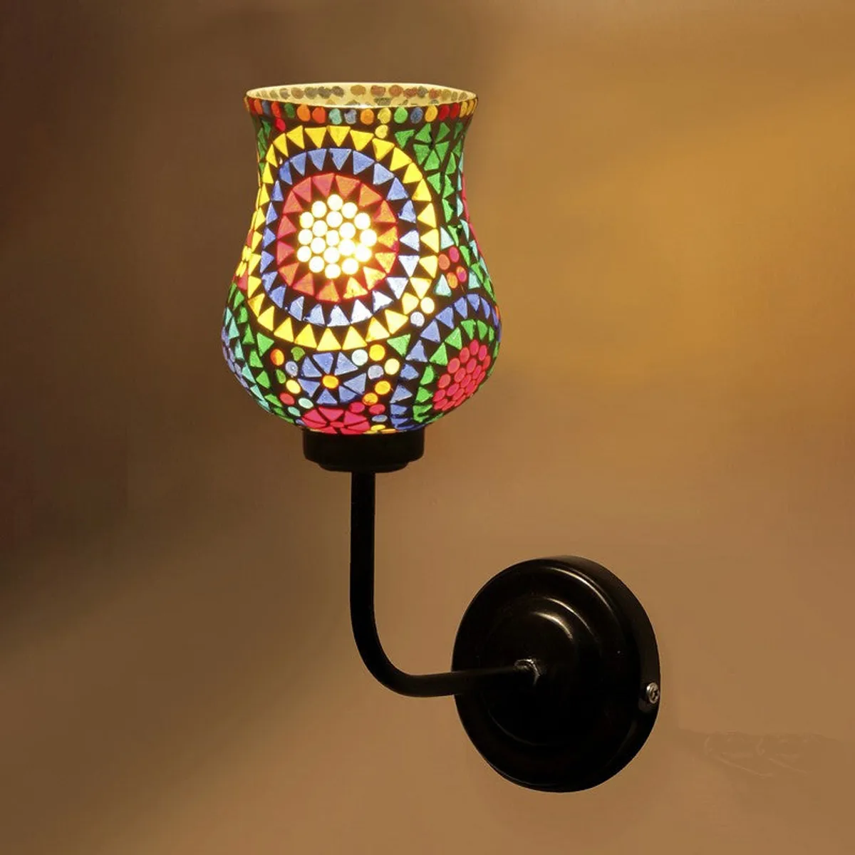 Close-up of lit mandala mosaic glass wall lamp with black wall mount