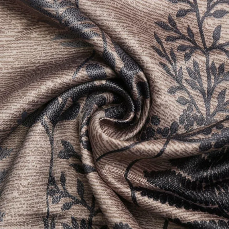 Close-up of brown artificial silk curtain fabric with dark botanical floral print