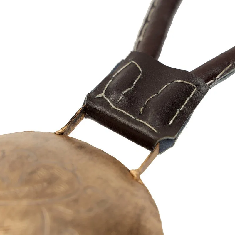 Close-up of the dark hanging loop and detailed gold bell surface