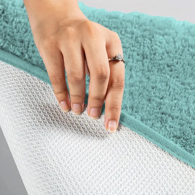 Underside of the aqua rug showing the anti-skid textured backing