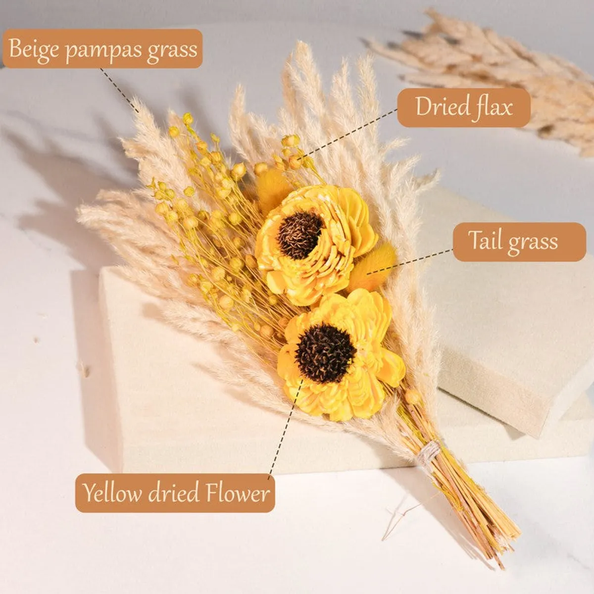 Close-up of yellow dried flowers with labelled beige pampas grass and dried stems