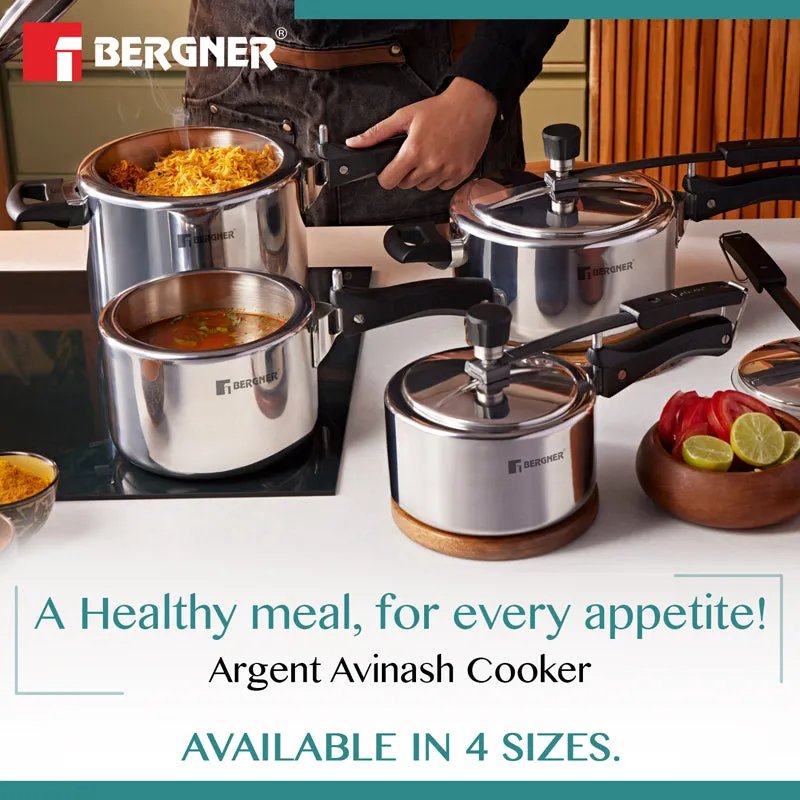 Several silver pressure cookers arranged with prepared food on a kitchen counter