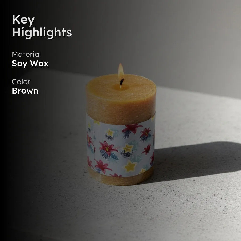 Lit brown pillar candle with floral wrap on a stone surface