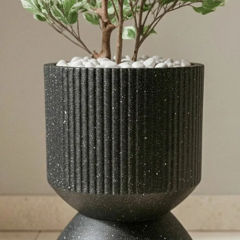 Close-up of vertical ribbing and speckled black finish on the planter.