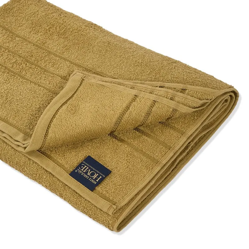 Close-up of folded olive green bath towel with border detail